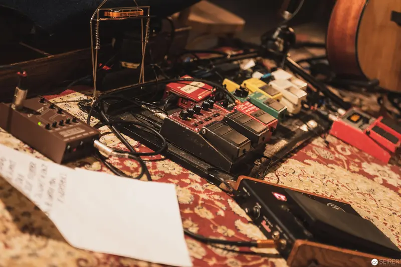 Analog Music Production Setup with Vintage Audio Equipment on Ornate Carpet