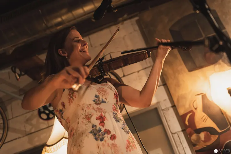 Passionate Violinist Performing in Intimate Industrial-Style Setting