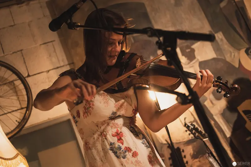 Violinist in Intimate Performance Amid Vintage Studio Setting