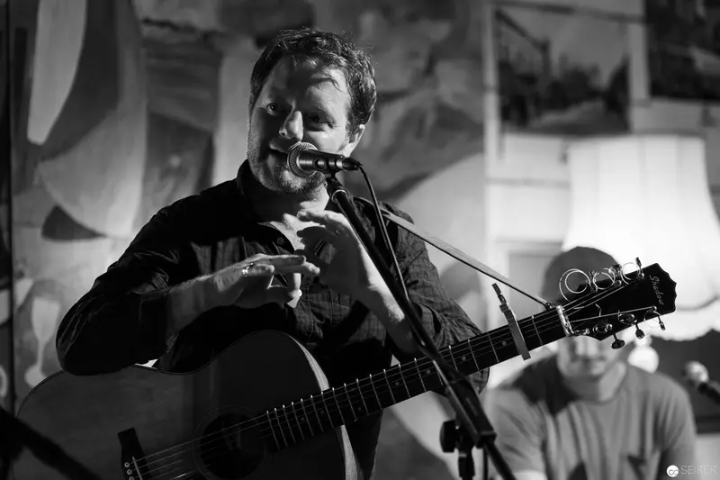 Acoustic Performer Singing with Intensity at Live Music Venue