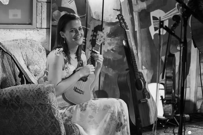 Contemplative Musician with Ukulele in Vintage Monochrome Studio Setting
