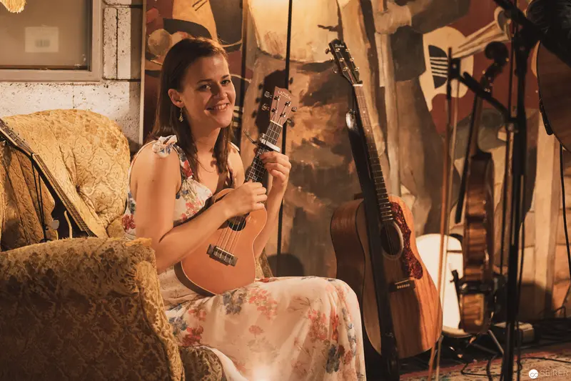 Ukulele Musician in Vintage Studio Setting with Warm Ambient Lighting
