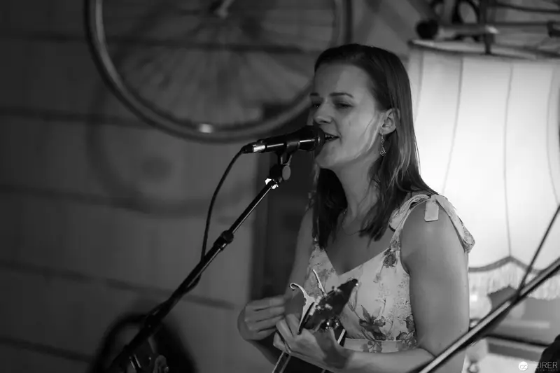 Passionate Solo Performance by Singer with Guitar in Black and White