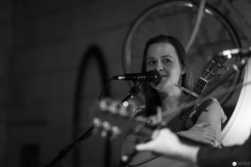 Black and White Performance: Singer-Songwriter at Intimate Microphone and Bass Guitar