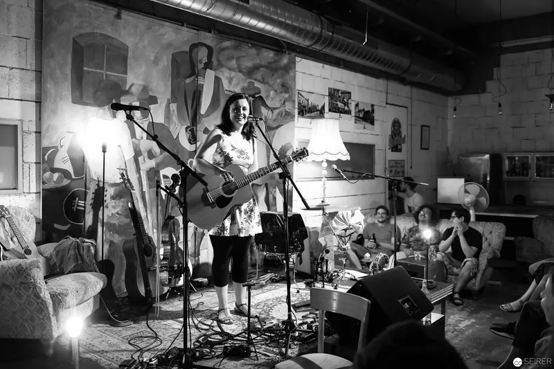 Intimate Acoustic Performance in Industrial-Style Venue with Small Audience
