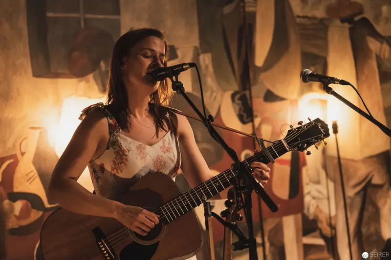 Acoustic Performance in Warm-Toned Intimate Setting with Dramatic Lighting
