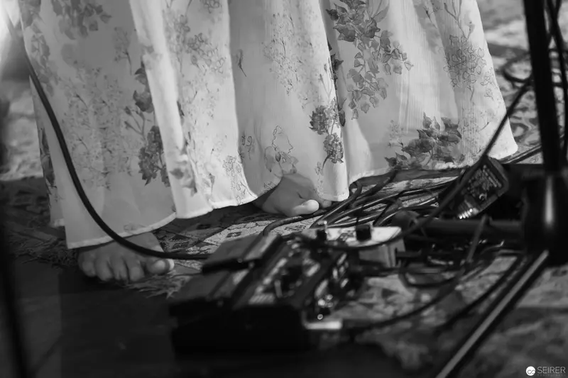 Barefoot Musician's Pedals and Flowing Fabric in Monochrome Performance