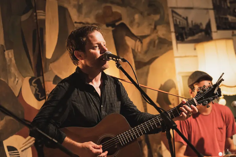 Intimate Acoustic Performance with Guitarist and Accompanist in Art-Filled Space