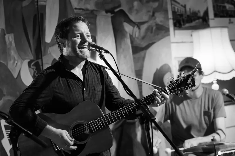Acoustic Performer Singing Passionately at Intimate Live Music Venue
