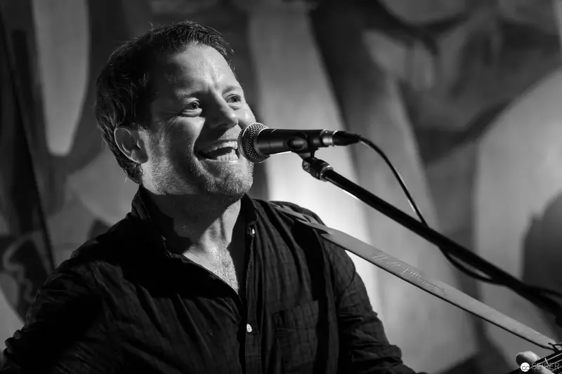 Singer Performing Passionately in Black and White Concert Photograph