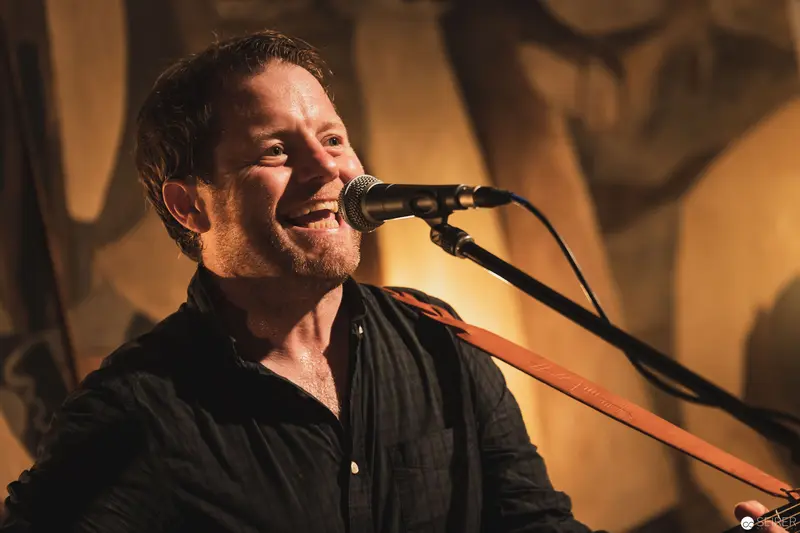 Performer Singing with Passionate Expression at Intimate Acoustic Concert