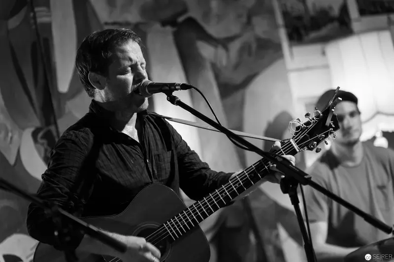 Black and White Performance with Acoustic Guitar and Vocal Microphone