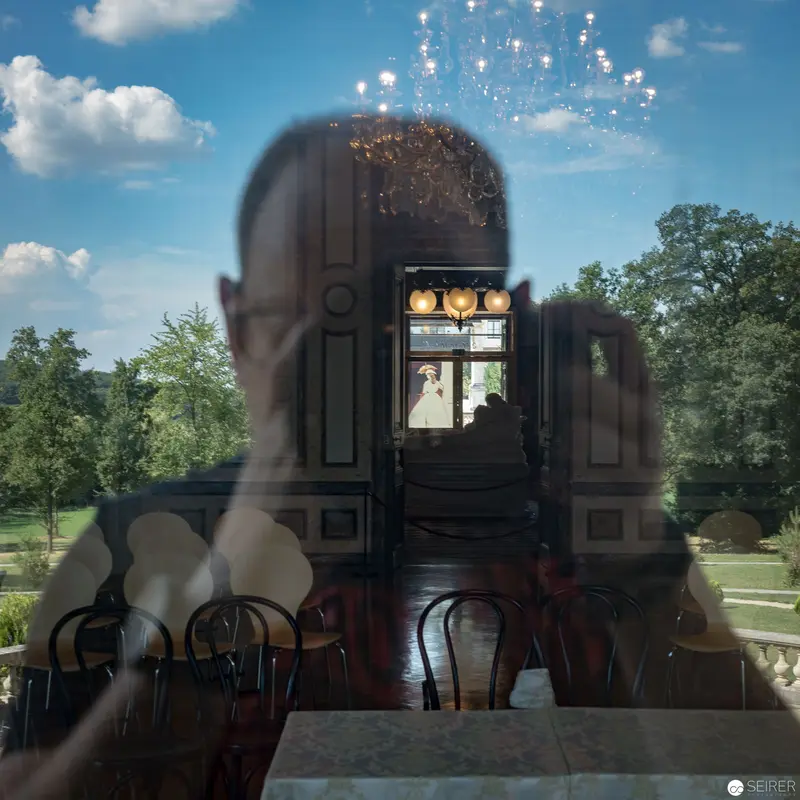 Reflective Dreamscape at Hermesvilla: Interior Tableau with Chandelier and Garden Vista