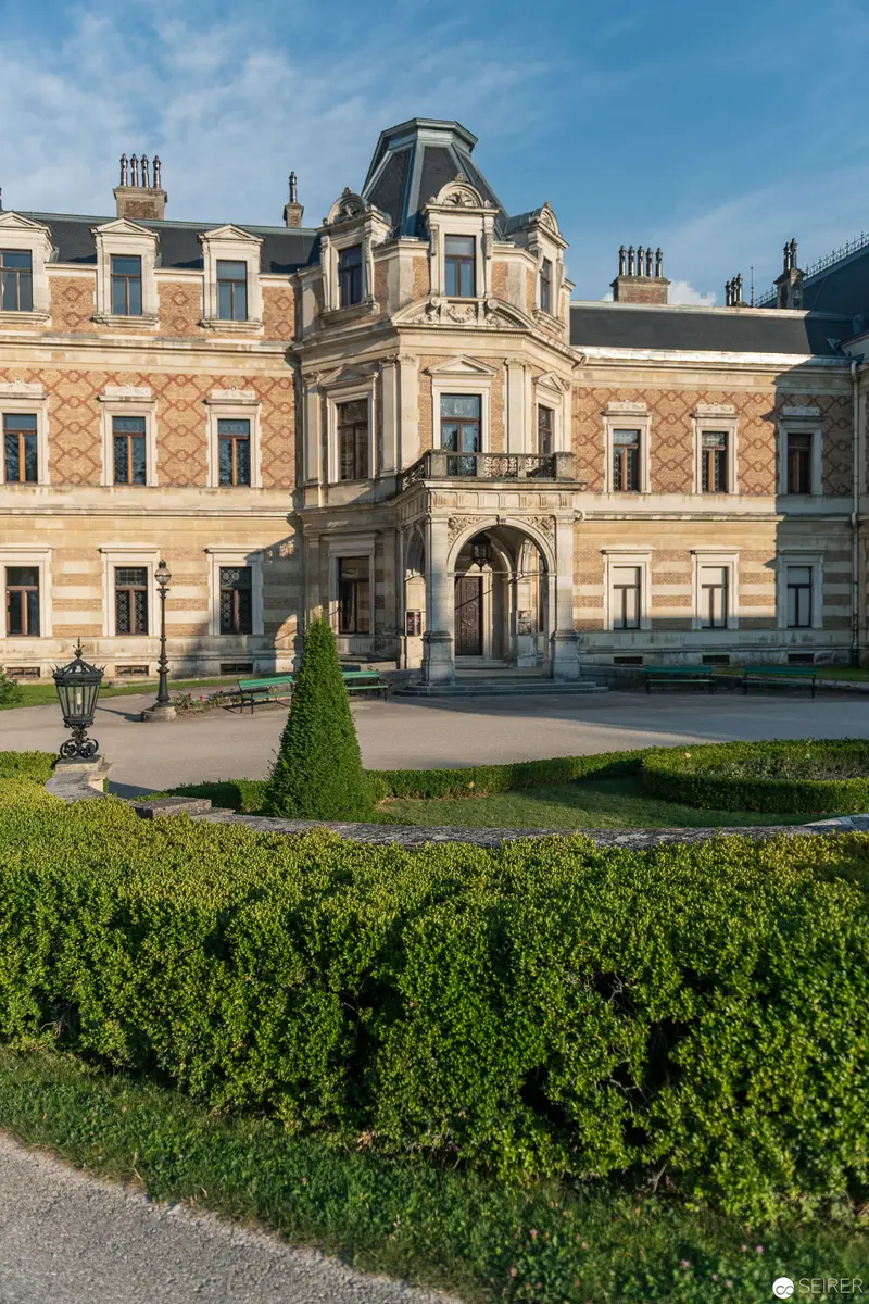 Hermesvilla Exterior: Ornate Baroque Palace with Manicured Landscape in Vienna