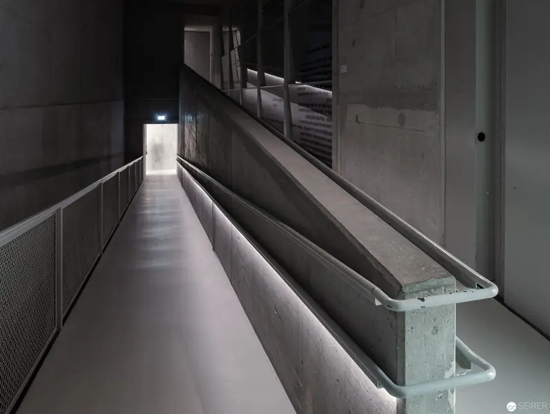 Minimalist Concrete Corridor with Soft Illumination and Architectural Geometry