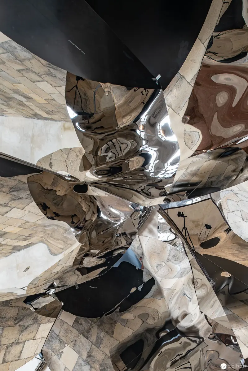 Distorted Reflective Surface Fragmenting Architectural Space in Abstract Composition