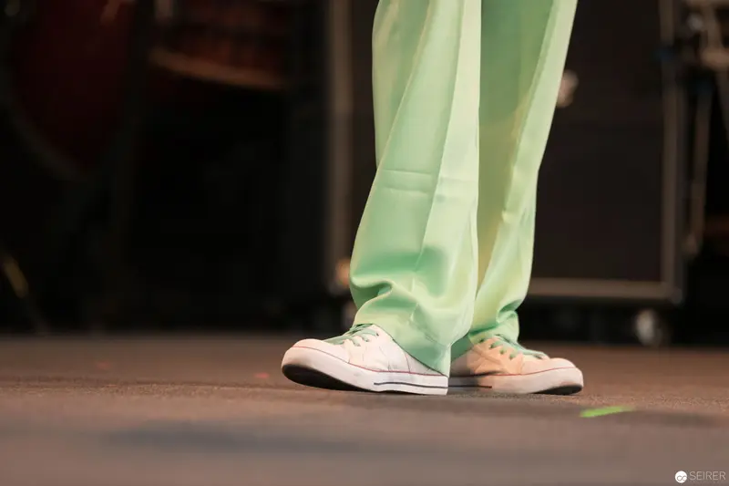 Mint Green Trousers and White Sneakers on Performance Stage Floor
