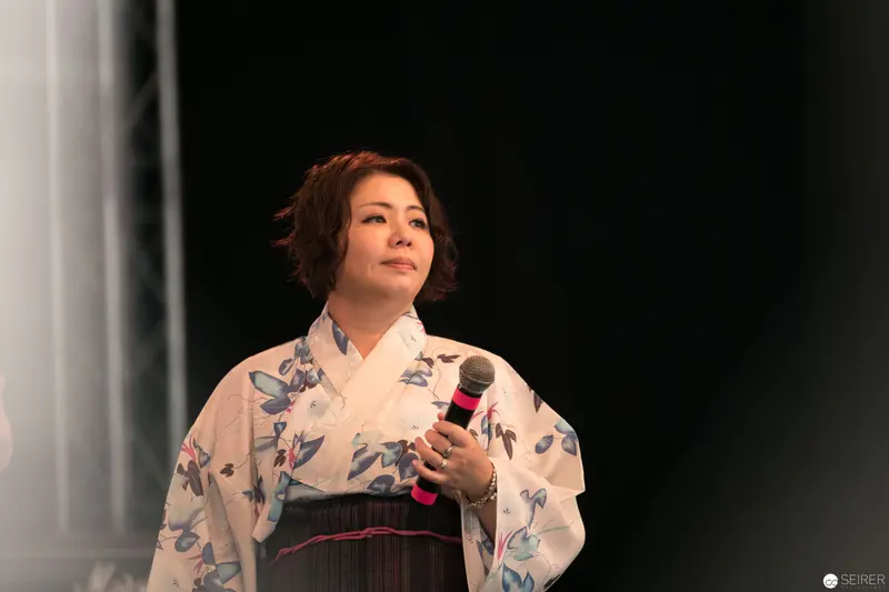 Female Performer in Floral Kimono Holding Microphone at AniNite 2018