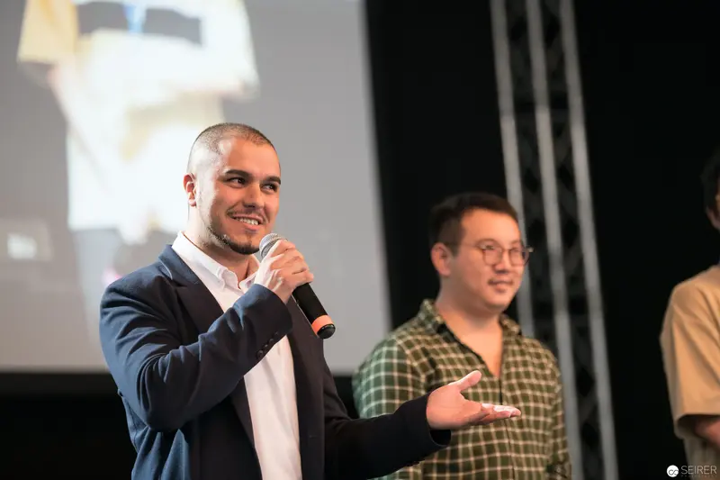 Speaker Presenting at AniNite 2018 Conference with Enthusiastic Gesture