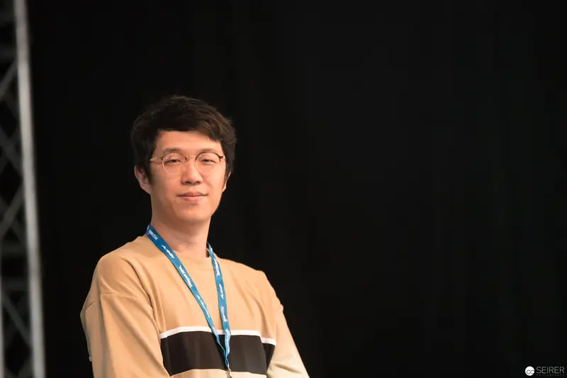 Young Asian Speaker at AniNite 2018 Conference in Contemplative Pose