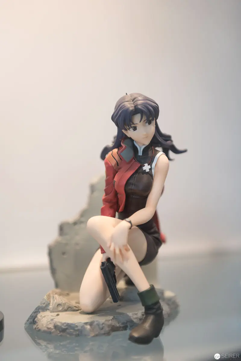 Anime Figure Sculpture of Female Character Seated on Rocky Base