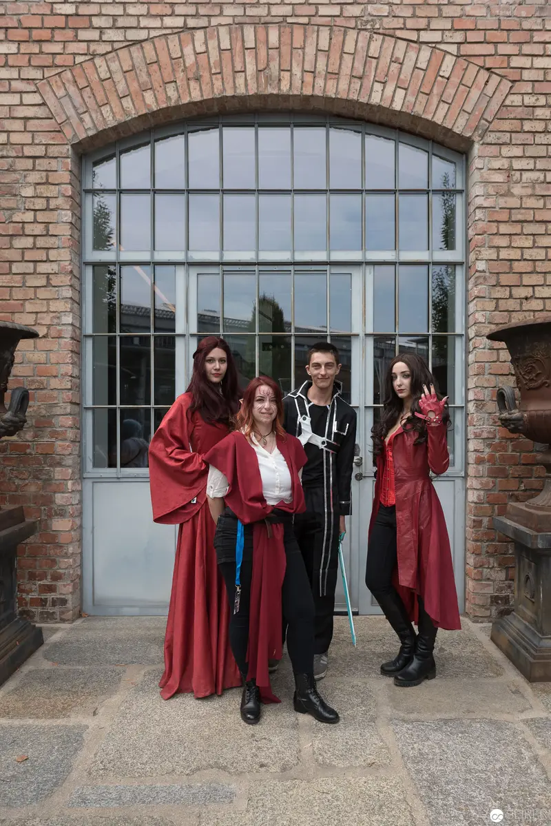 Gothic Costumed Quartet Posing at Brick Architectural Venue
