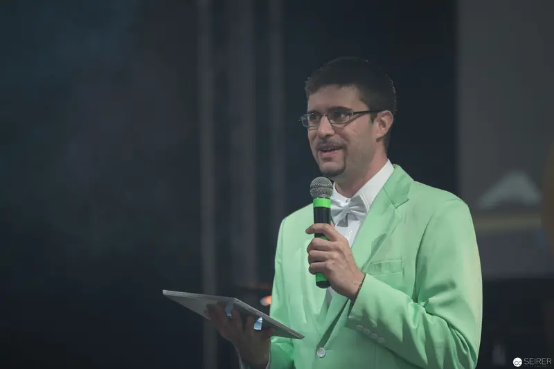 Presenter in Mint Green Jacket Delivering Speech at AniNite 2018 Conference