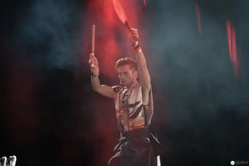 Dramatic Drummer Performing at AniNite 2018 with Raised Drumsticks