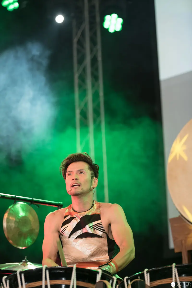 Drummer Performing with Intense Green Stage Lighting at AniNite 2018