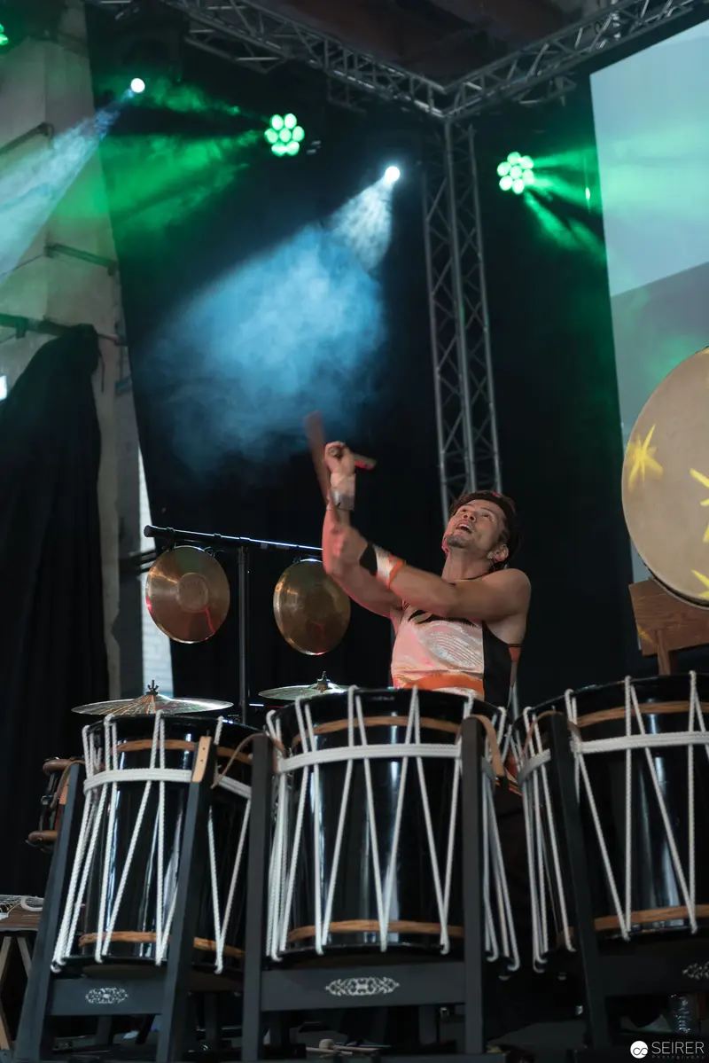 Drummer Performing Under Green Stage Lights at AniNite 2018 Music Event