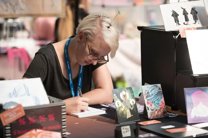 Artist Concentrating at Event Booth During AniNite 2018 Convention