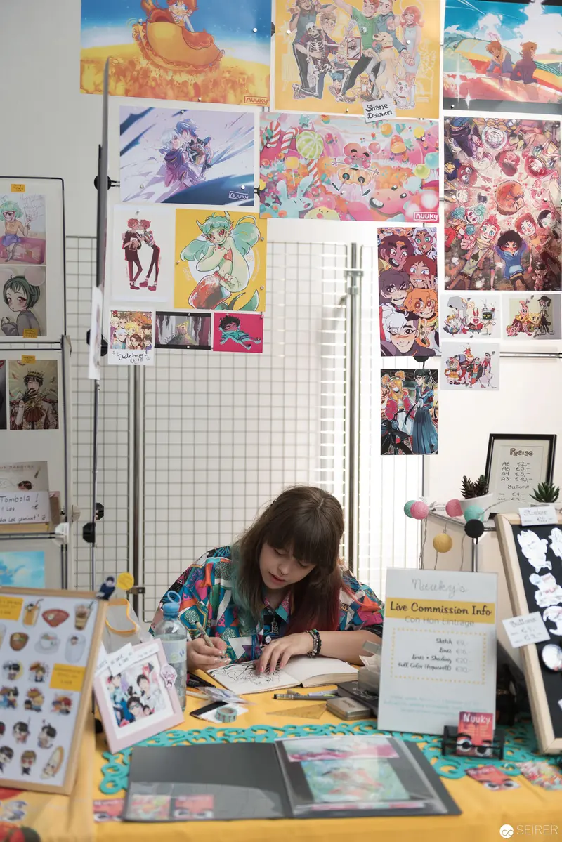 Artist's Workspace: Colorful Illustration Studio with Vibrant Wall Display