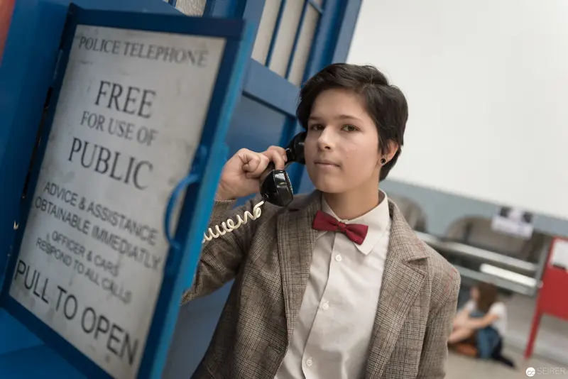 Youth in Tweed Jacket Using Vintage Police Box Telephone