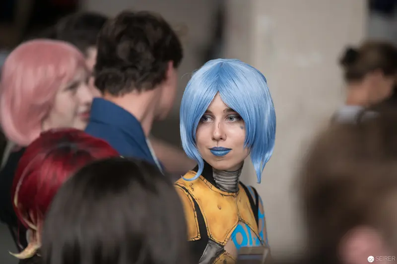 Blue-Haired Cosplayer in Yellow Jacket at AniNite 2018 Convention