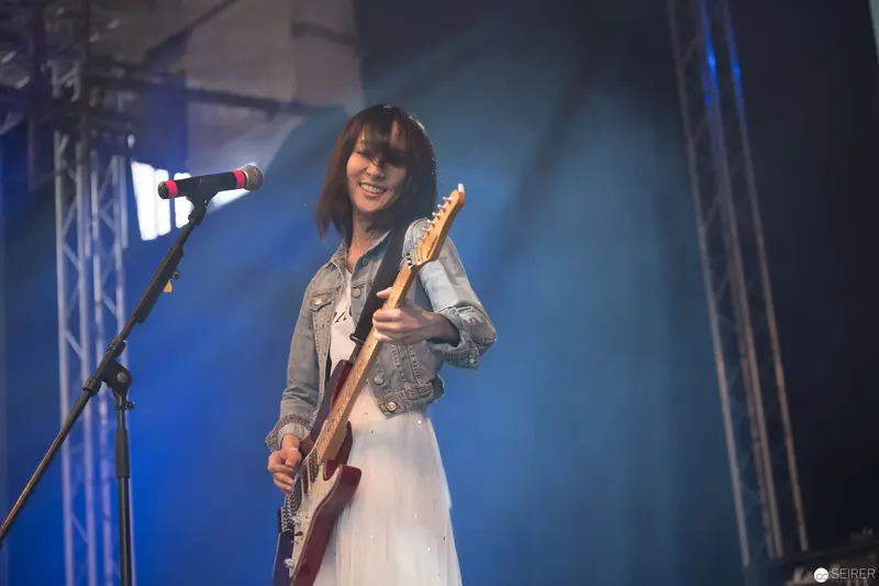 Haruka Performing Live at AniNite 2018 with Electric Guitar on Blue-Lit Stage