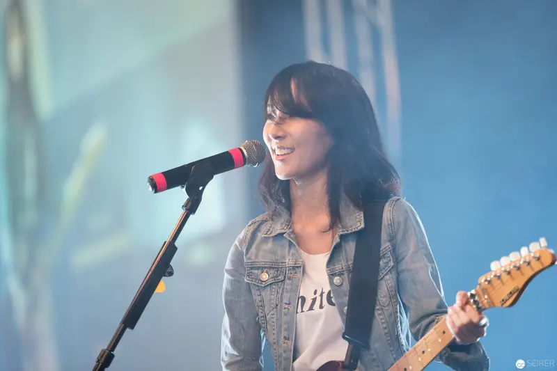 Female Musician Performing with Guitar at AniNite 2018 Music Event