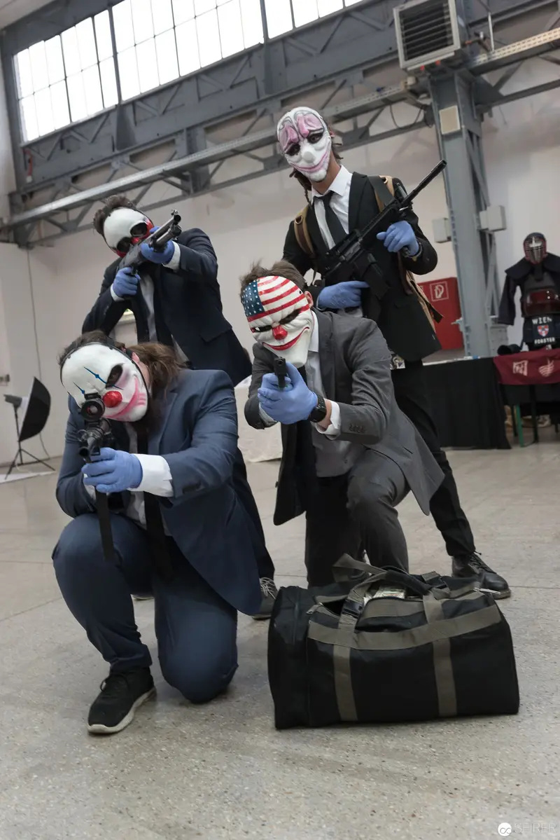 Costumed Performers with Payday Masks Posing in Industrial Space