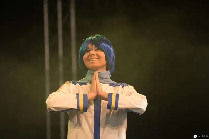 Blue-Wigged Performer in Meditative Pose at AniNite 2018 Performance