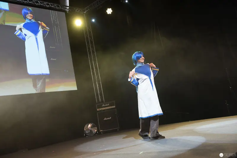 Blue-Haired Cosplayer Performs on Stage at AniNite 2018 Anime Convention