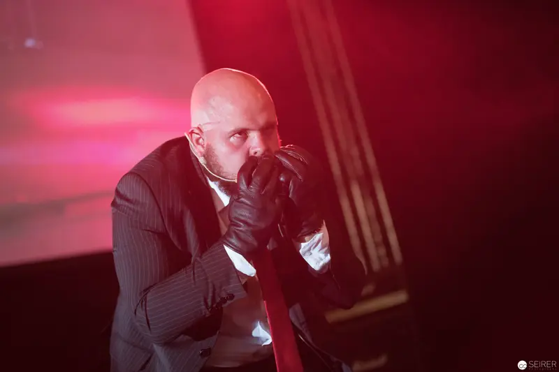 Dramatic Performance at AniNite 2018 with Bald Performer in Dramatic Red Lighting