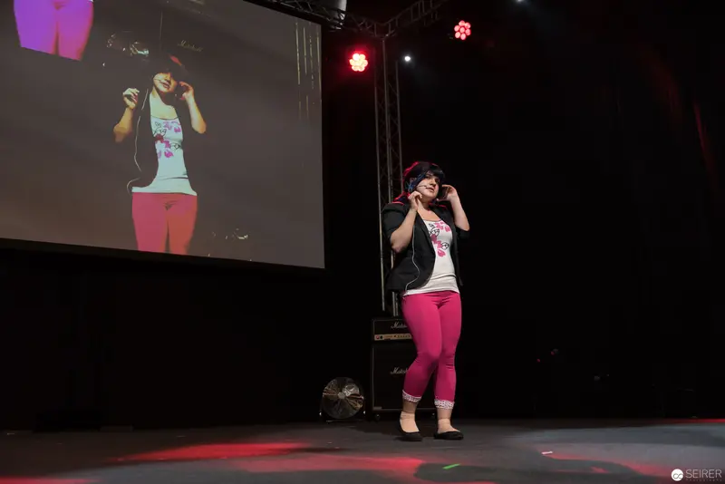 Performer on Stage at AniNite 2018 Concert with Projected Background