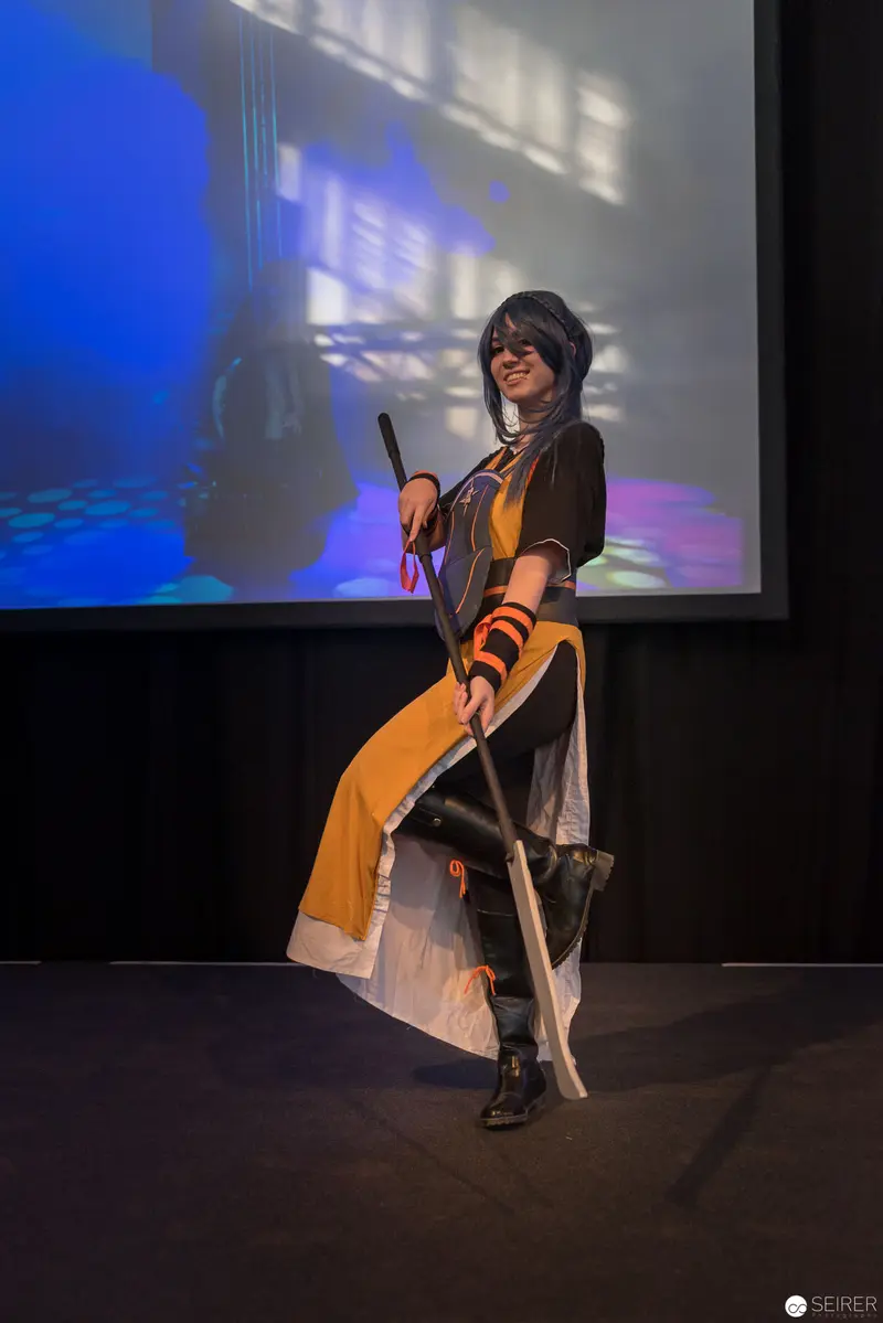 AniNite 2018: Costumed Performer Posing with Prop Sword on Dark Stage