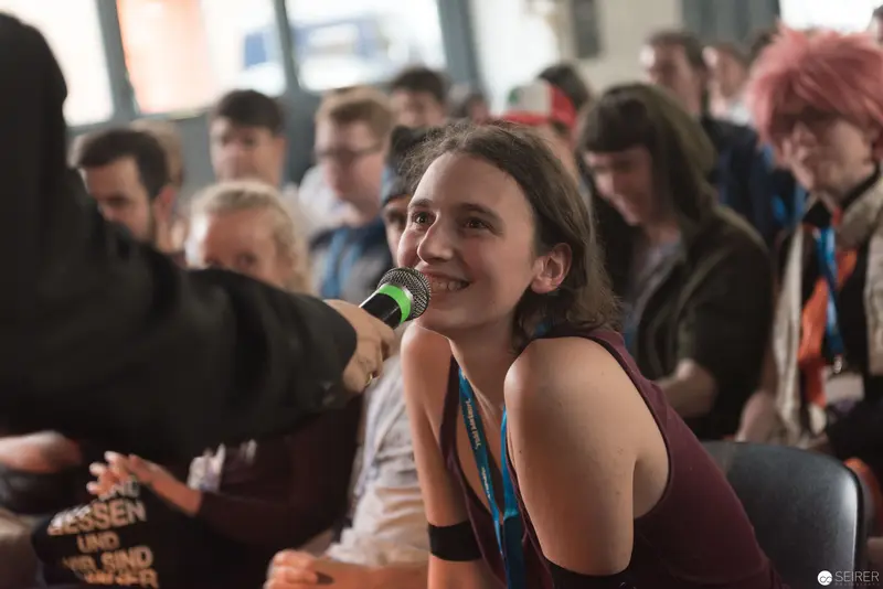 Young Speaker Engaging Audience During AniNite 2018 Conference Event