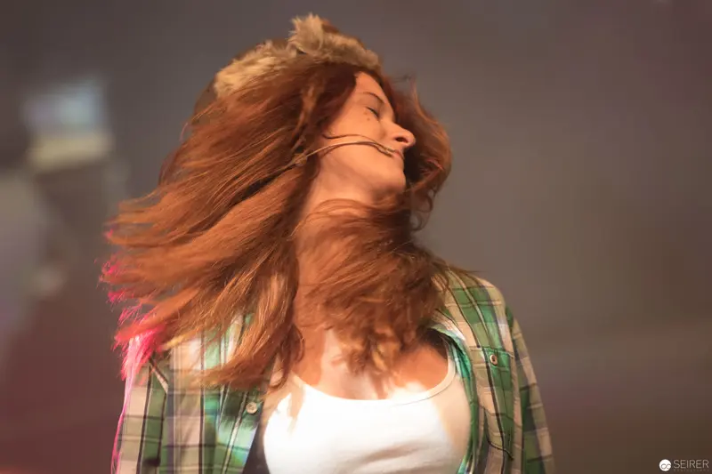 Windswept Motion: Dynamic Hair Silhouette in Plaid Shirt