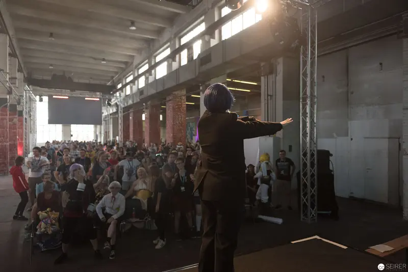 AniNite 2018: Speaker Presenting to Crowded Industrial Event Space