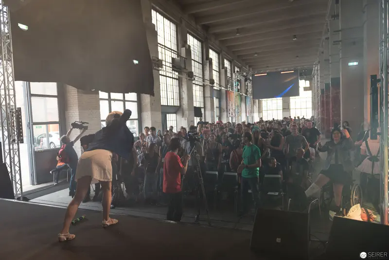 AniNite 2018: Crowded Performance Space with Dramatic Backlighting and Audience Silhouettes