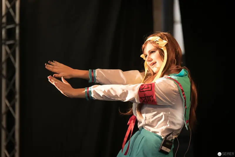 Performer in Folkloric Costume Gesturing Dramatically at AniNite 2018 Performance