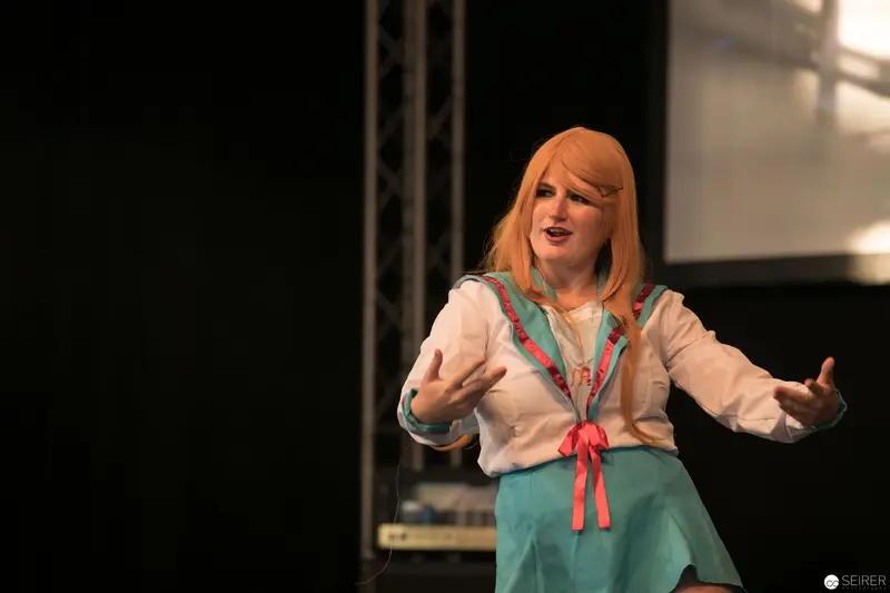 Performer in Blue and White Gesturing Dramatically at AniNite 2018 Stage