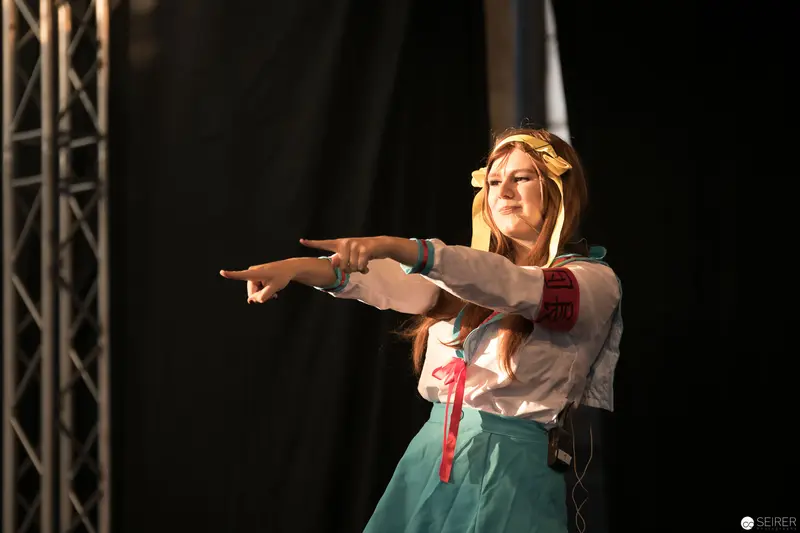 AniNite 2018 Performance: Performer in Folkloric Costume Gesturing Dramatically on Stage