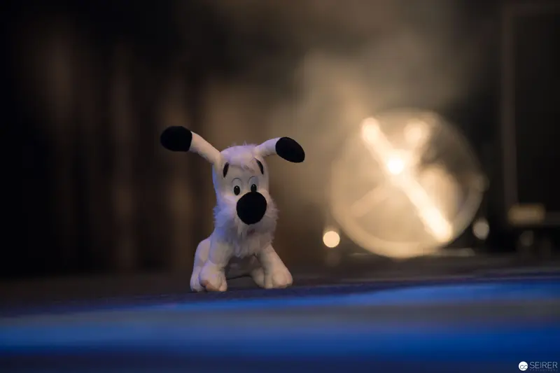 White Plush Toy Dog Under Atmospheric Blue Lighting with Soft Background Glow